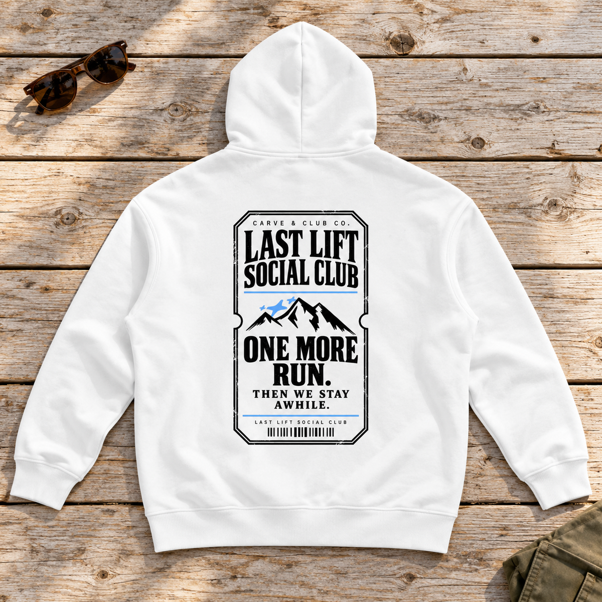 Last Lift Ticket Hoodie — back view flat lay on wood tabletop
