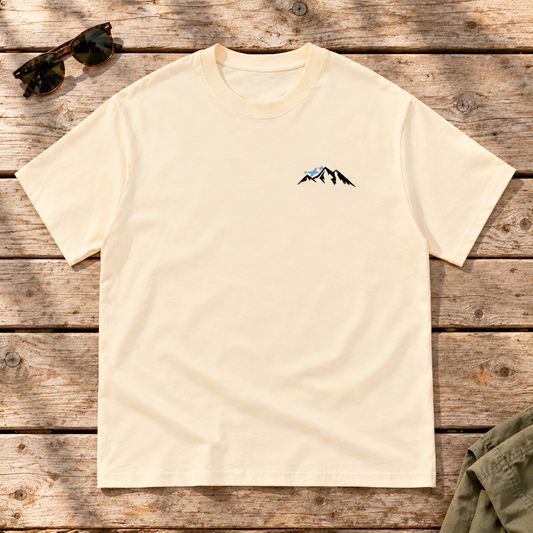 Last Lift Social Club Tee — front view flat lay on wood tabletop