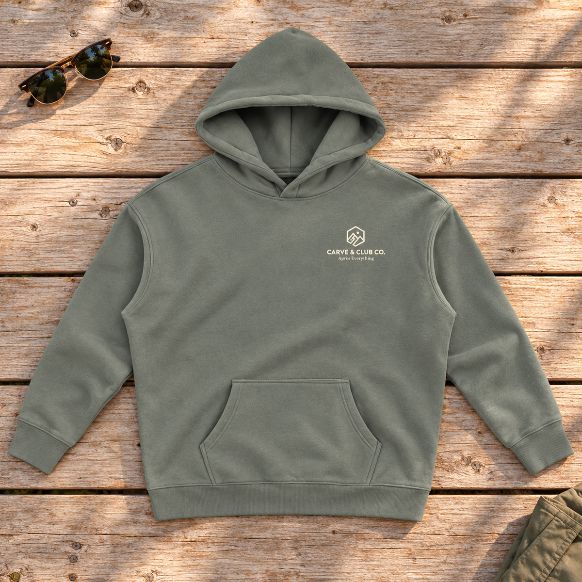 Après Everything Signature Hoodie — front view flat lay on wood tabletop