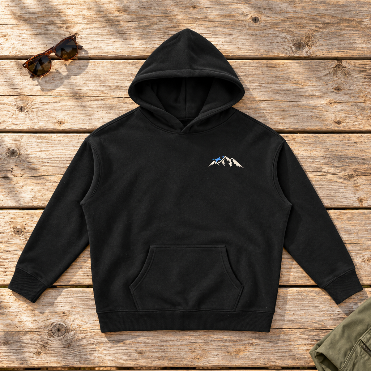 Last Lift Ticket Hoodie — front view flat lay on wood tabletop