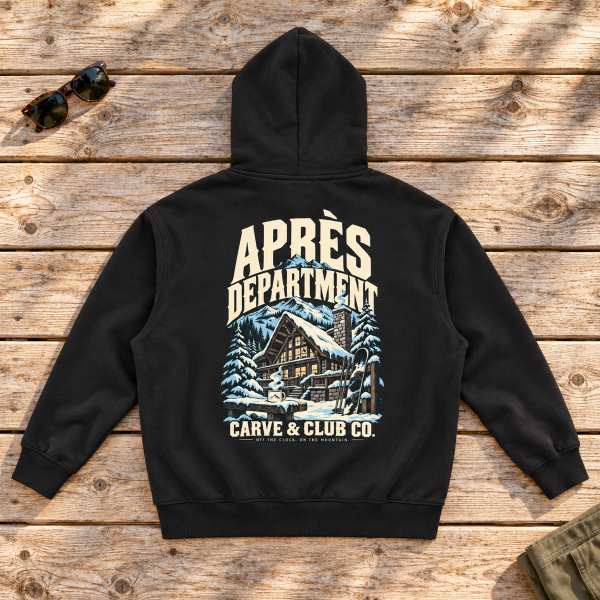 Aprés Department Hoodie — back view flat lay on wood tabletop
