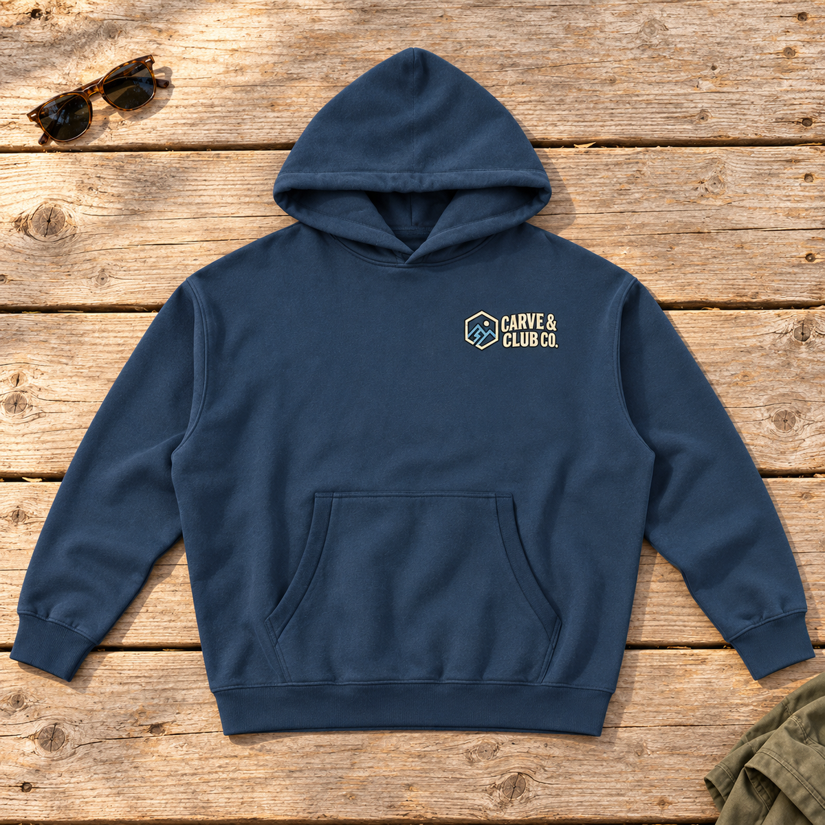 Aprés Department Hoodie — front view flat lay on wood tabletop