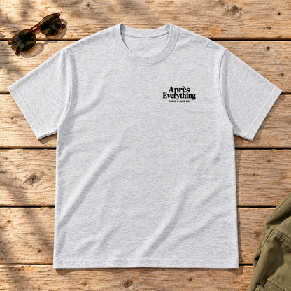 The Après Definition Tee — front view flat lay on wood tabletop