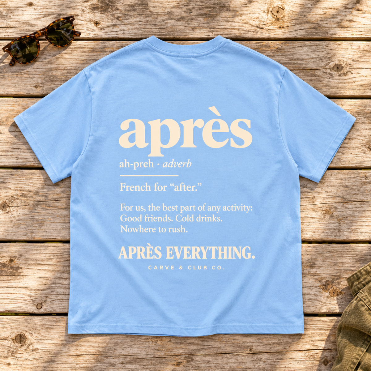 The Après Definition Tee — back view flat lay on wood tabletop