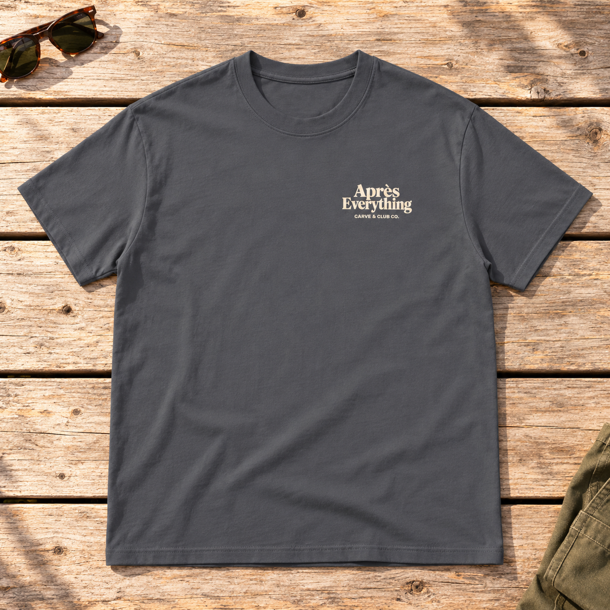 The Après Definition Tee — front view flat lay on wood tabletop