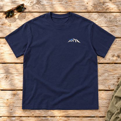 Last Lift Social Club Tee — front view flat lay on wood tabletop