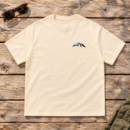 Last Lift Ticket Tee — front view flat lay on wood tabletop