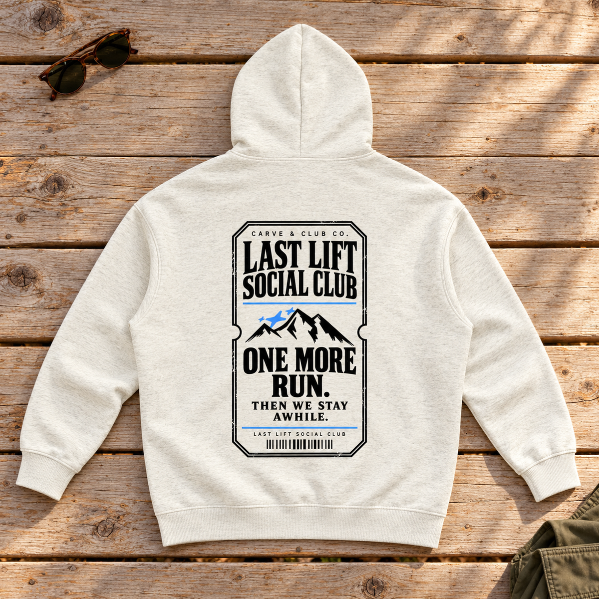 Last Lift Ticket Hoodie — back view flat lay on wood tabletop