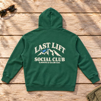 Last Lift Social Club Hoodie — back view flat lay on wood tabletop