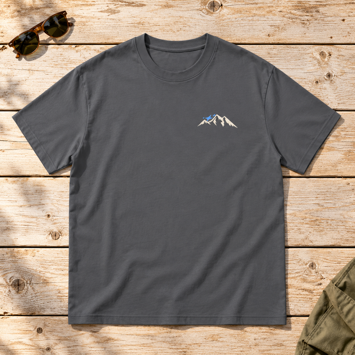 Last Lift Ticket Tee — front view flat lay on wood tabletop