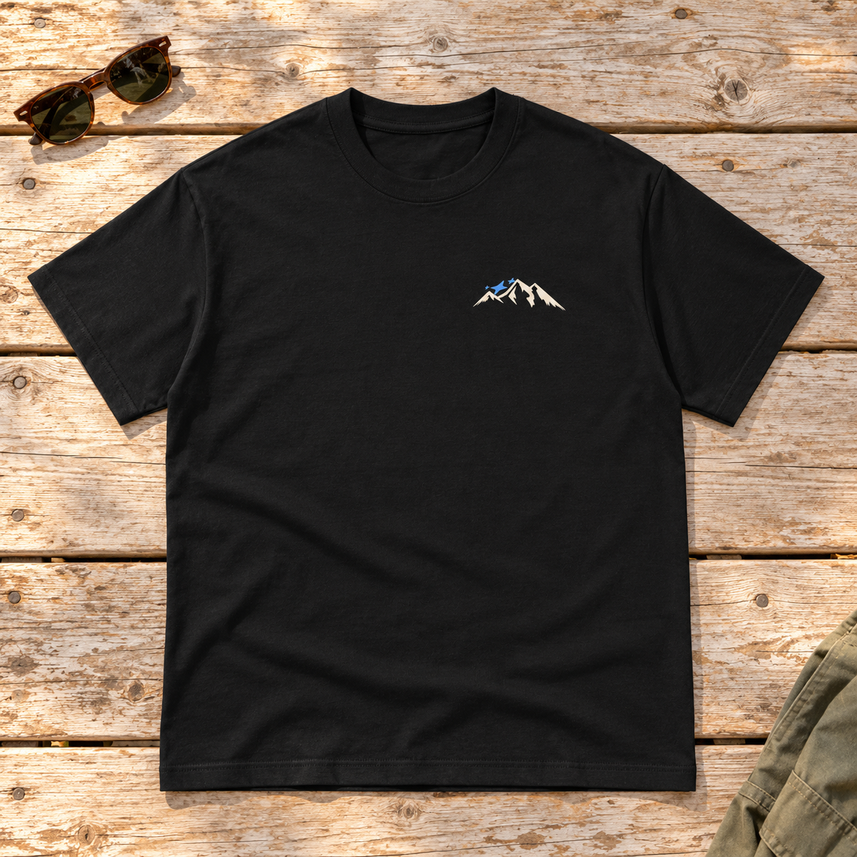 Last Lift Ticket Tee — front view flat lay on wood tabletop