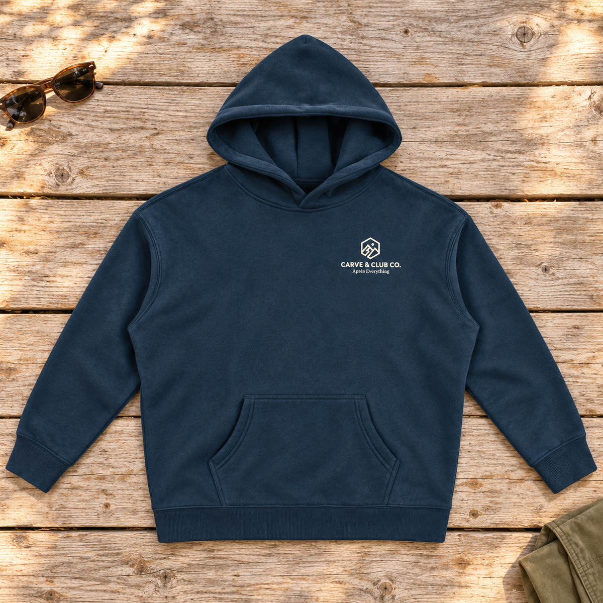 Après Everything Signature Hoodie — front view flat lay on wood tabletop