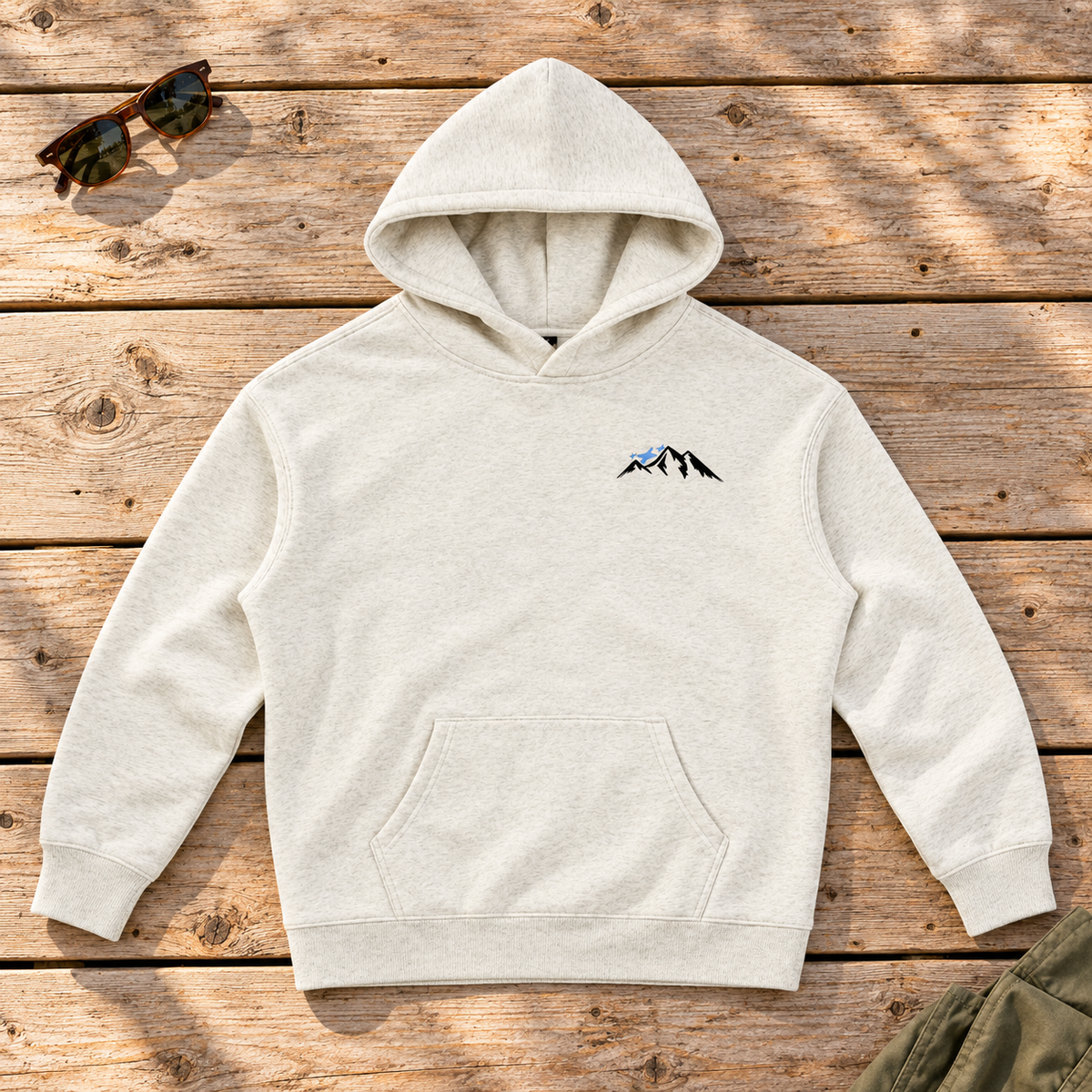 Last Lift Ticket Hoodie — front view flat lay on wood tabletop