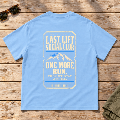 Last Lift Ticket Tee — back view flat lay on wood tabletop