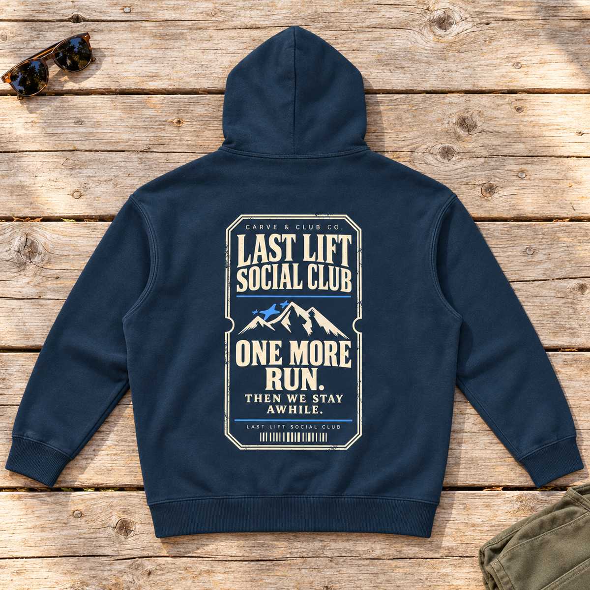 Last Lift Ticket Hoodie — back view flat lay on wood tabletop