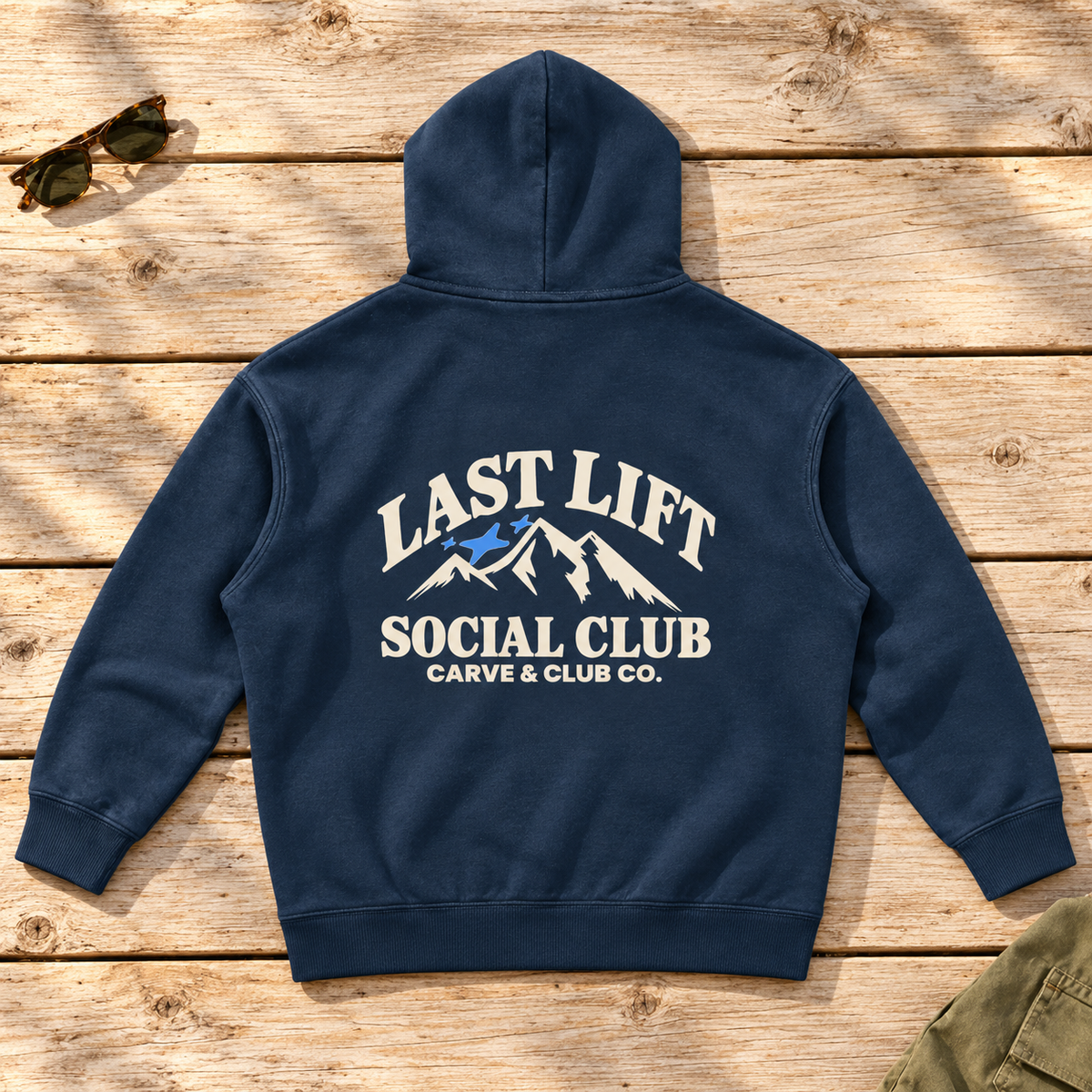 Last Lift Social Club Hoodie — back view flat lay on wood tabletop