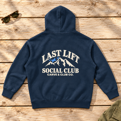 Last Lift Social Club Hoodie — back view flat lay on wood tabletop