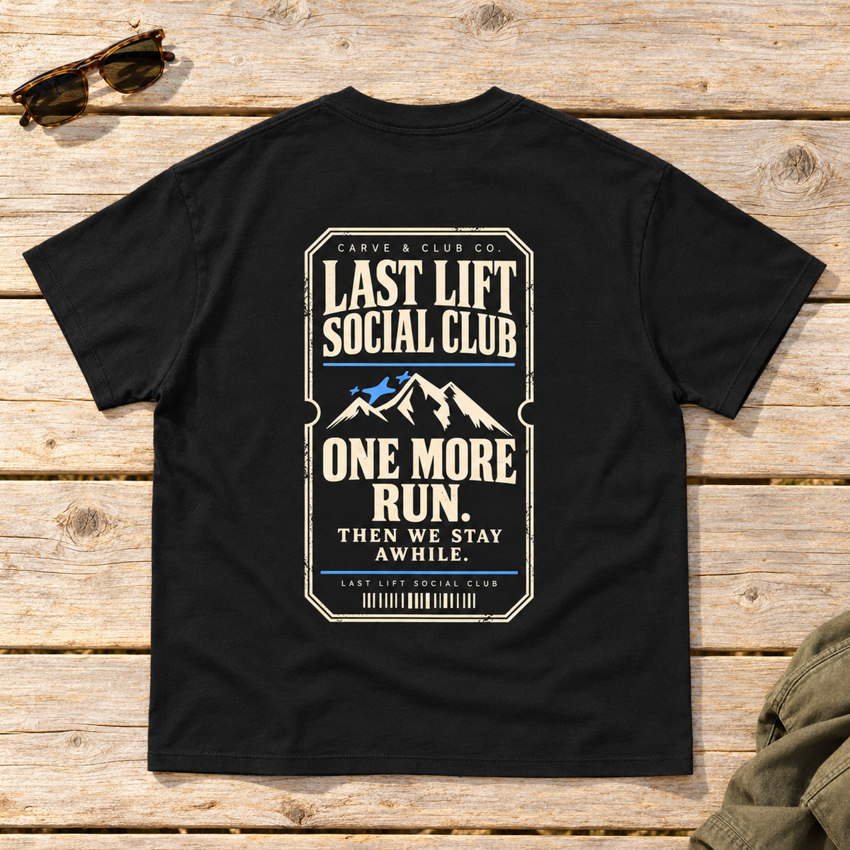 Last Lift Ticket Tee — back view flat lay on wood tabletop