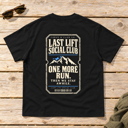 Last Lift Ticket Tee — back view flat lay on wood tabletop