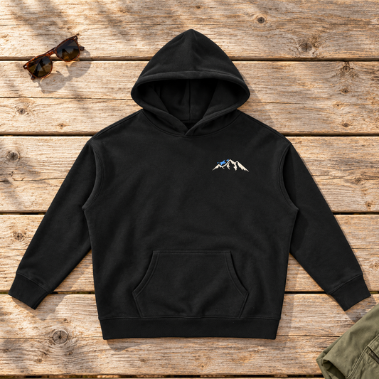 Last Lift Ticket Hoodie — front view flat lay on wood tabletop