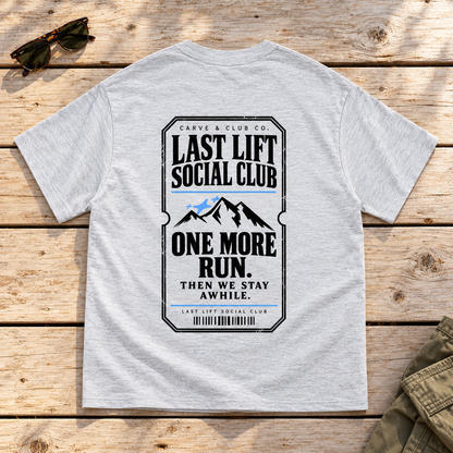 Last Lift Ticket Tee — back view flat lay on wood tabletop