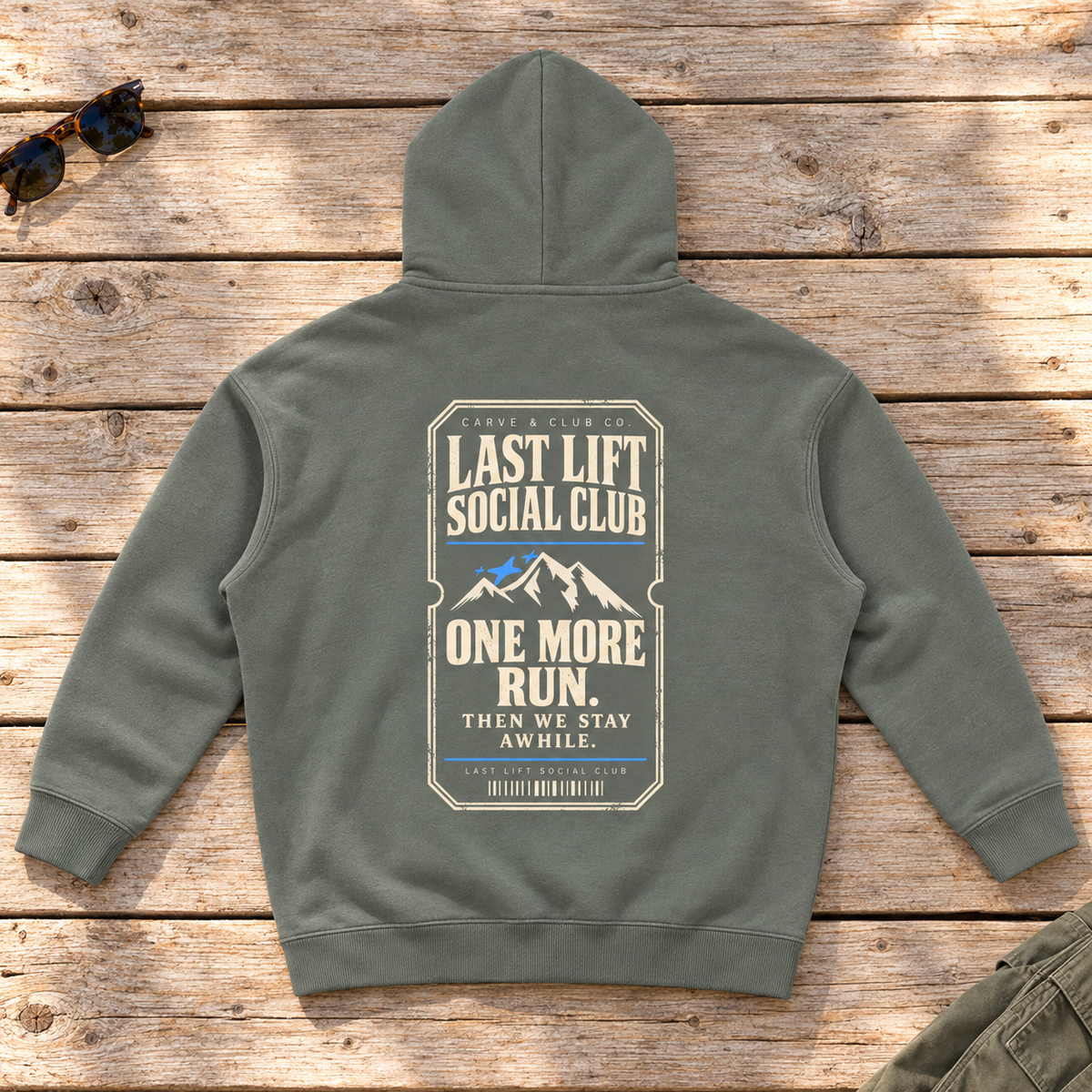 Last Lift Ticket Hoodie — back view flat lay on wood tabletop