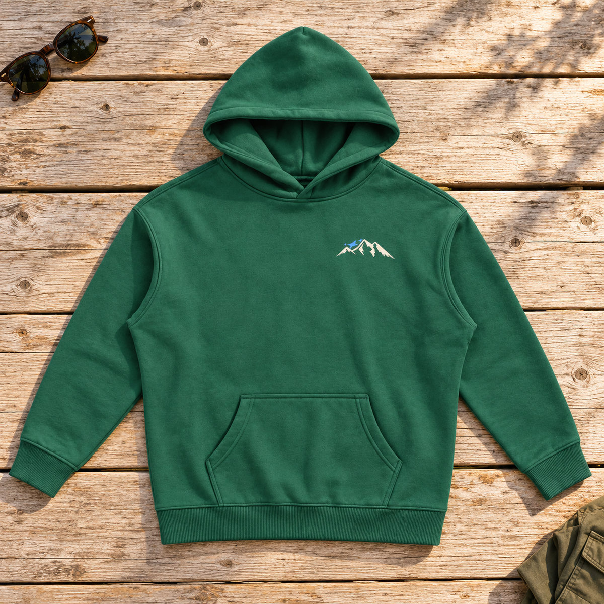 Last Lift Social Club Hoodie — front view flat lay on wood tabletop
