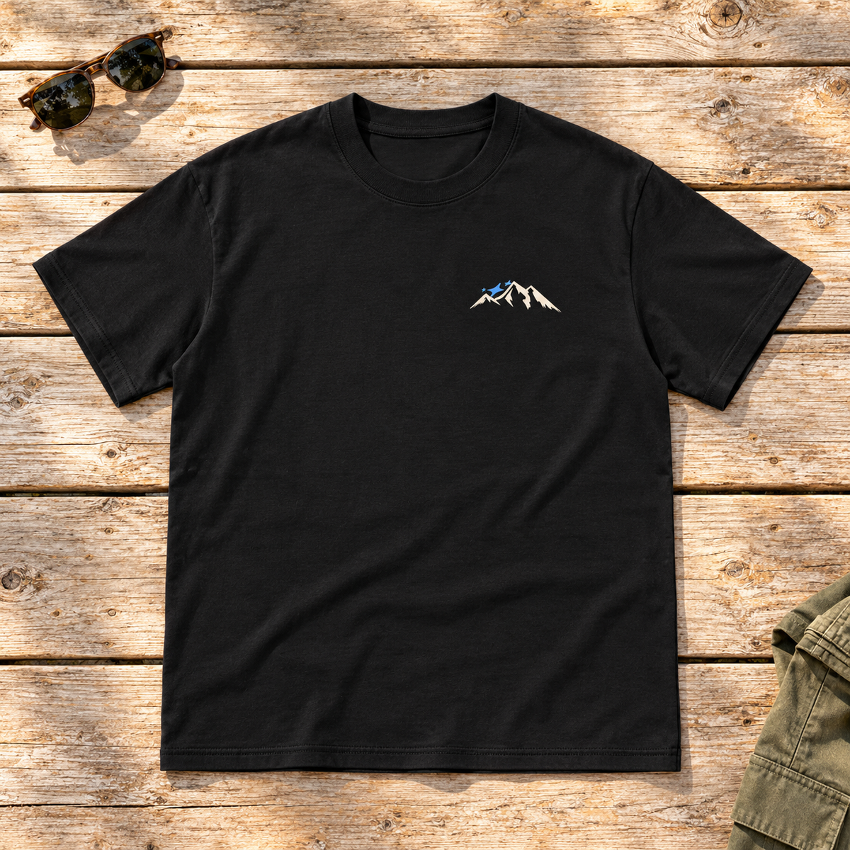 Last Lift Social Club Tee — front view flat lay on wood tabletop