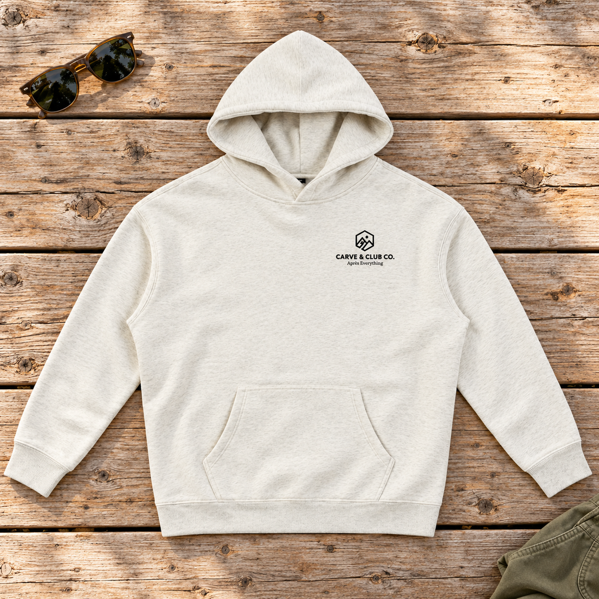 Après Everything Signature Hoodie — front view flat lay on wood tabletop