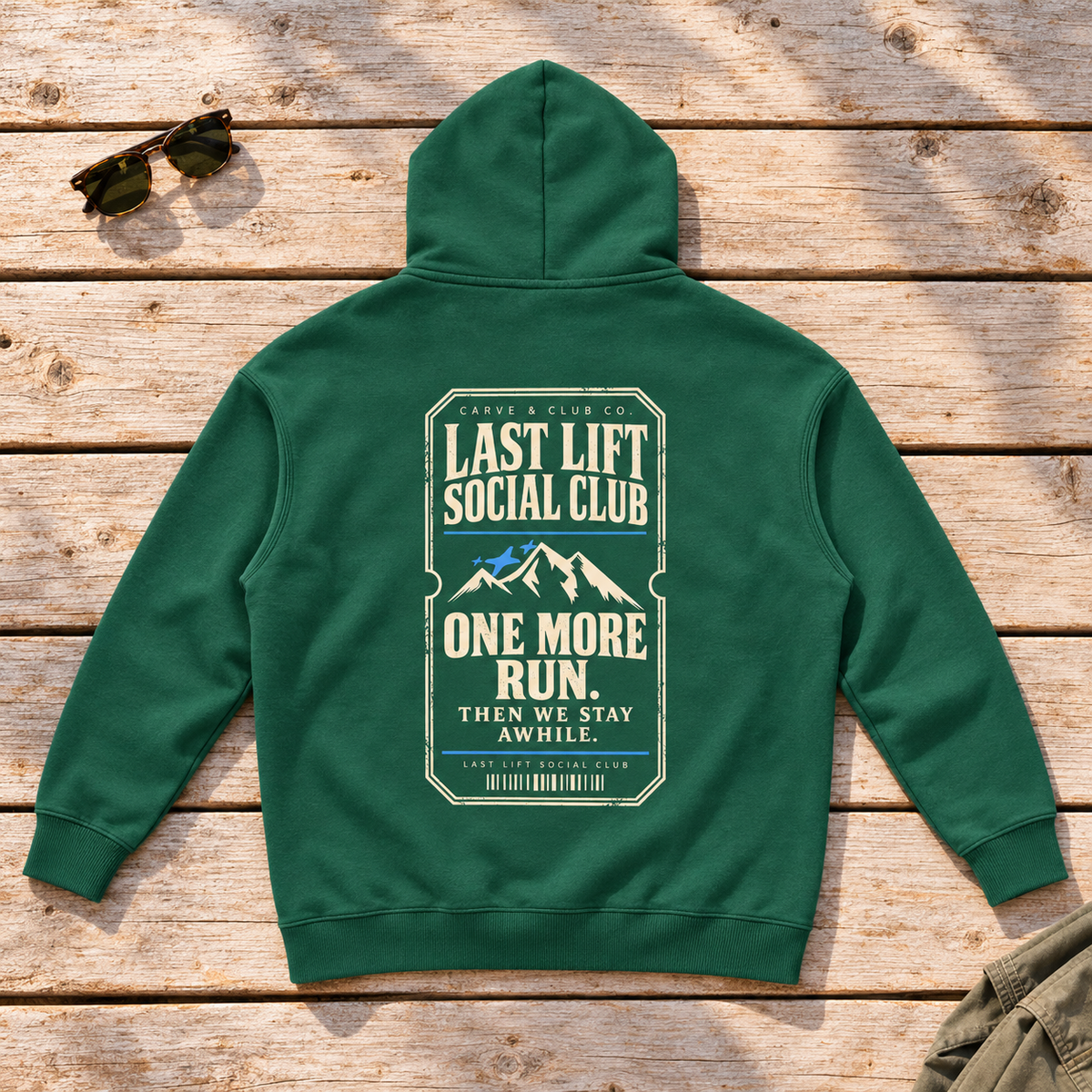 Last Lift Ticket Hoodie — back view flat lay on wood tabletop