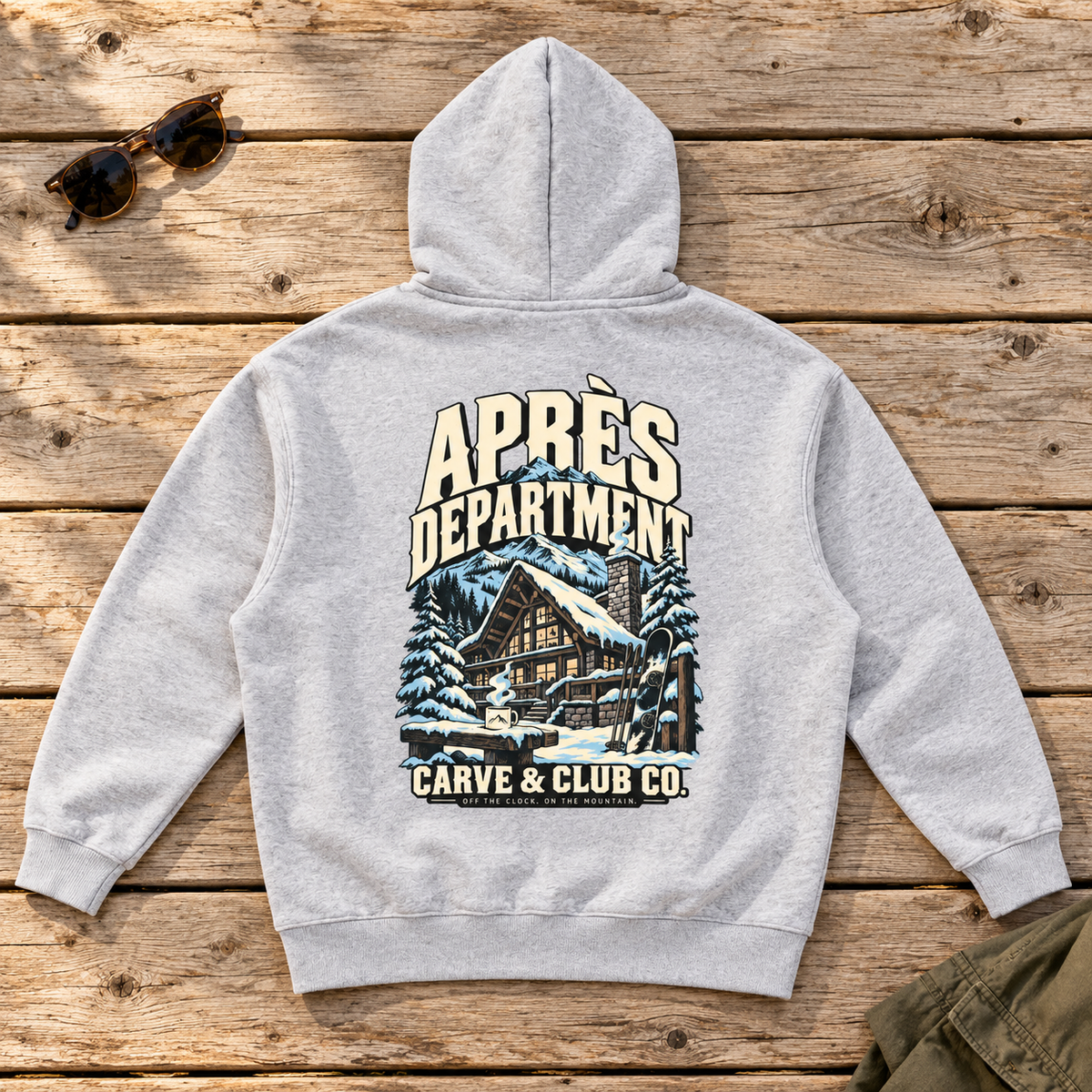 Aprés Department Hoodie — back view flat lay on a wood tabletop