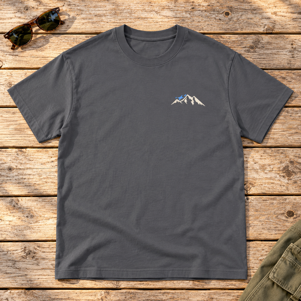 Last Lift Social Club Tee — front view flat lay on wood tabletop