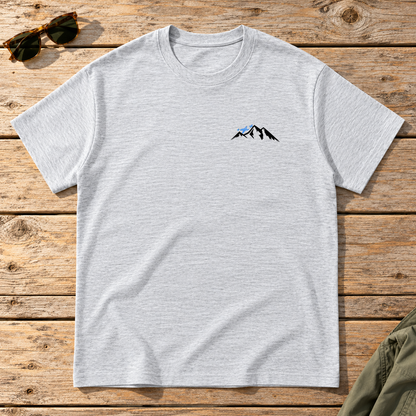 Last Lift Social Club Tee — front view flat lay on wood tabletop