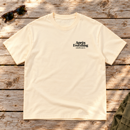The Après Definition Tee — front view flat lay on wood tabletop